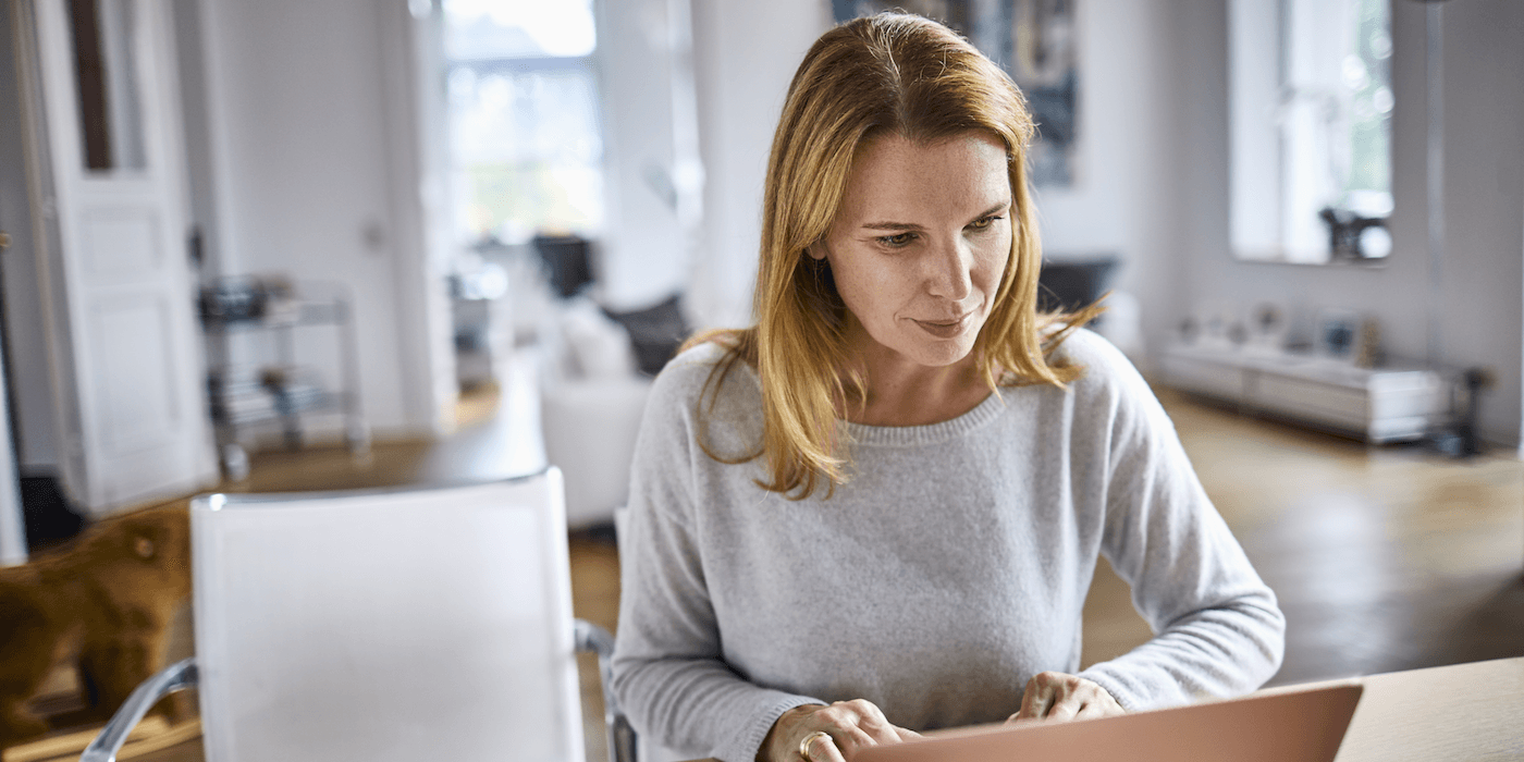person sitting at home working on a laptop